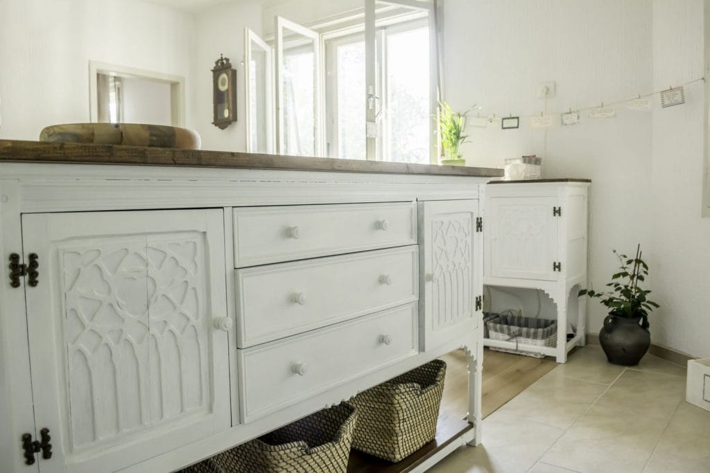 Antique credence painted white to make the room look fresh.