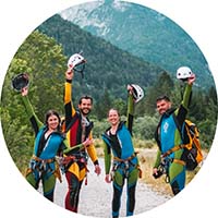 Smiling crazy stag party participants doing canyoning in Slovenia.